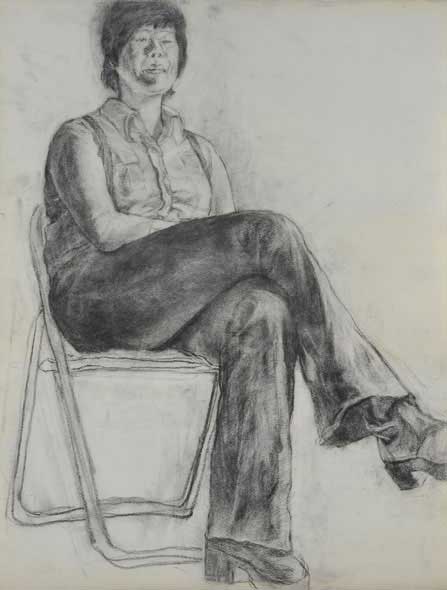 A woman sits on a chair.